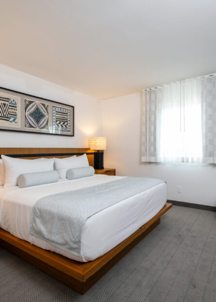 Signature Mahalo King Suite with King bed and island inspired artwork at our Wildwood Crest hotel