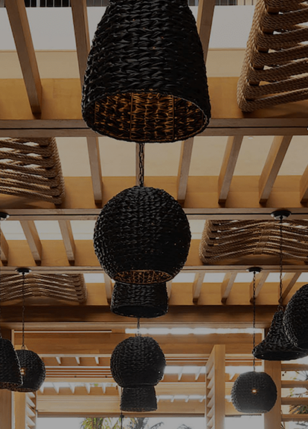 Wicker lights in a wooden-beam ceiling