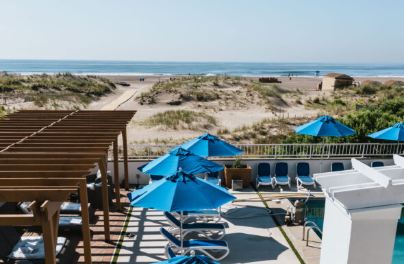Overlooking the pool at our Wildwood Crest hotel with umbrellas, the beach in the background