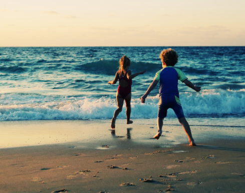 Two kids walking on the beach