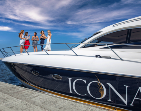 5 women stand on the bow of the ICONA Yacht, one the best Wildwood Crest activities