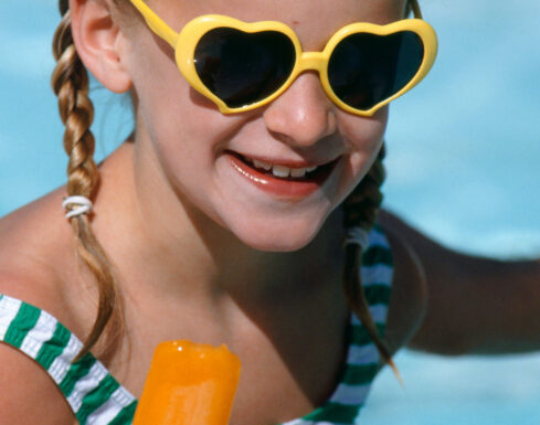 Young girl in yellow sunglasses enjoys a popsicle at our Wildwood Crest hotel