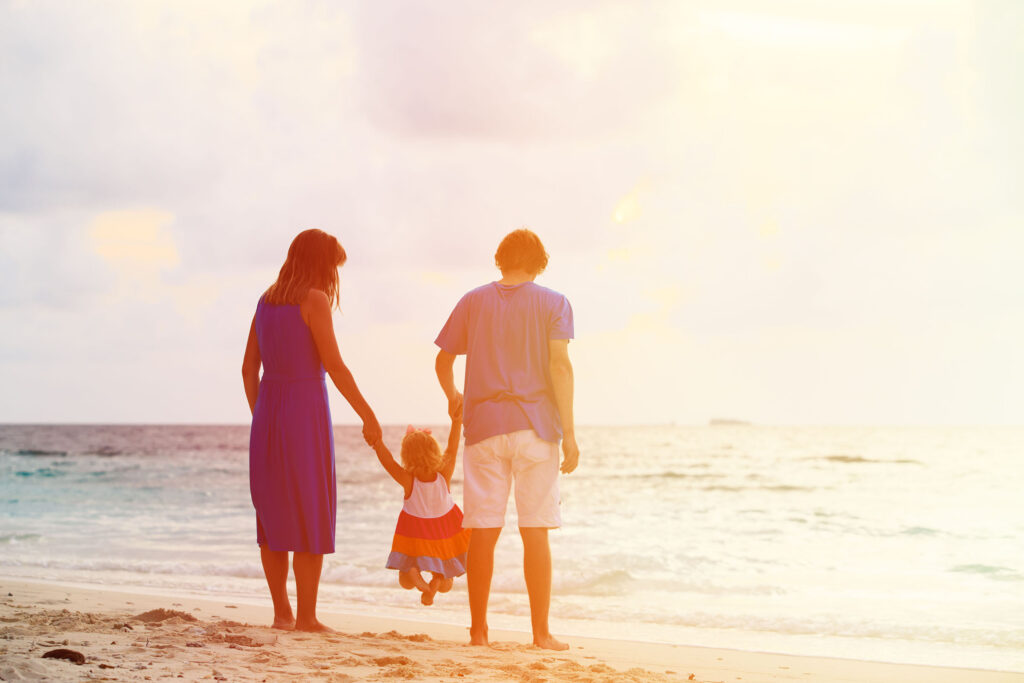 happy family with kid having fun on sunset beach