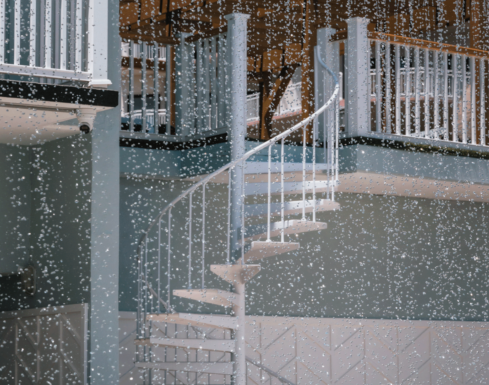 A staircase seen through the pool waterfall at our Diamond Beach resort