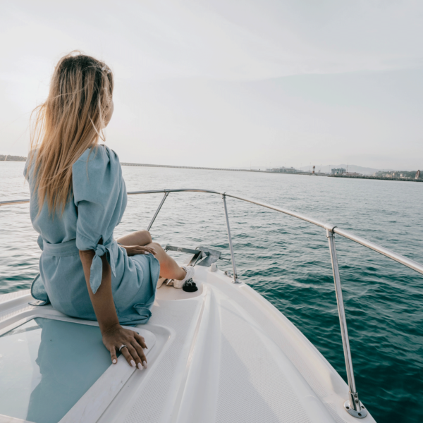 A woman sits on the bow of the ICONA Yacht one of the best Wildwood Crest activities