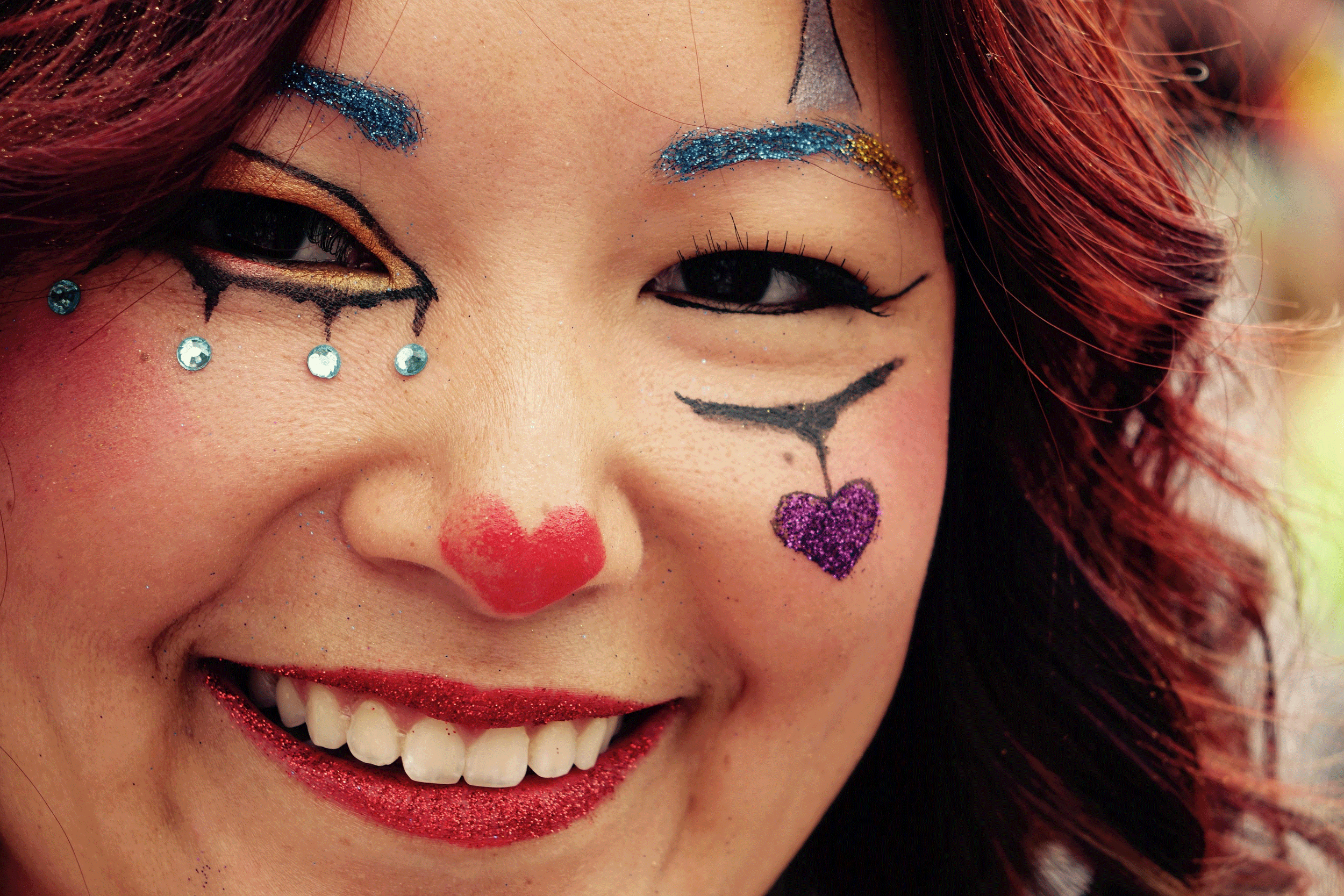 Woman with sparkly face paint smiling