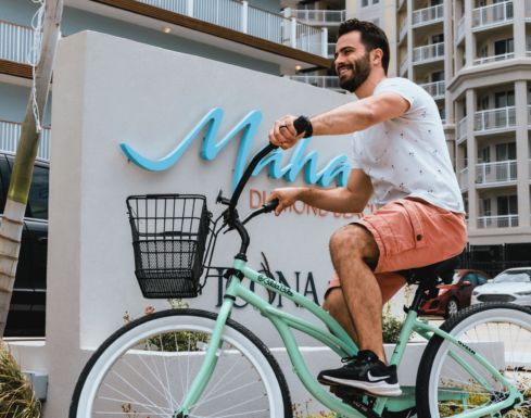 A man rides a cruiser bike near the entrance to our Diamond Beach hotel