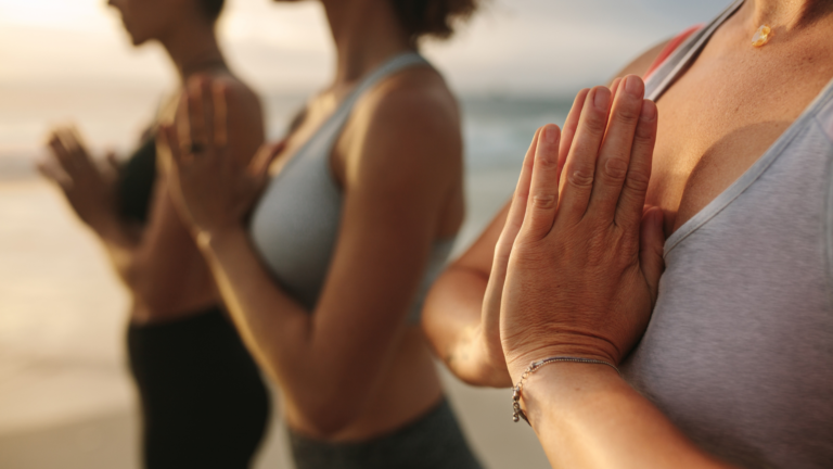 Closeup of women doing yoga on the beach in Wildwood