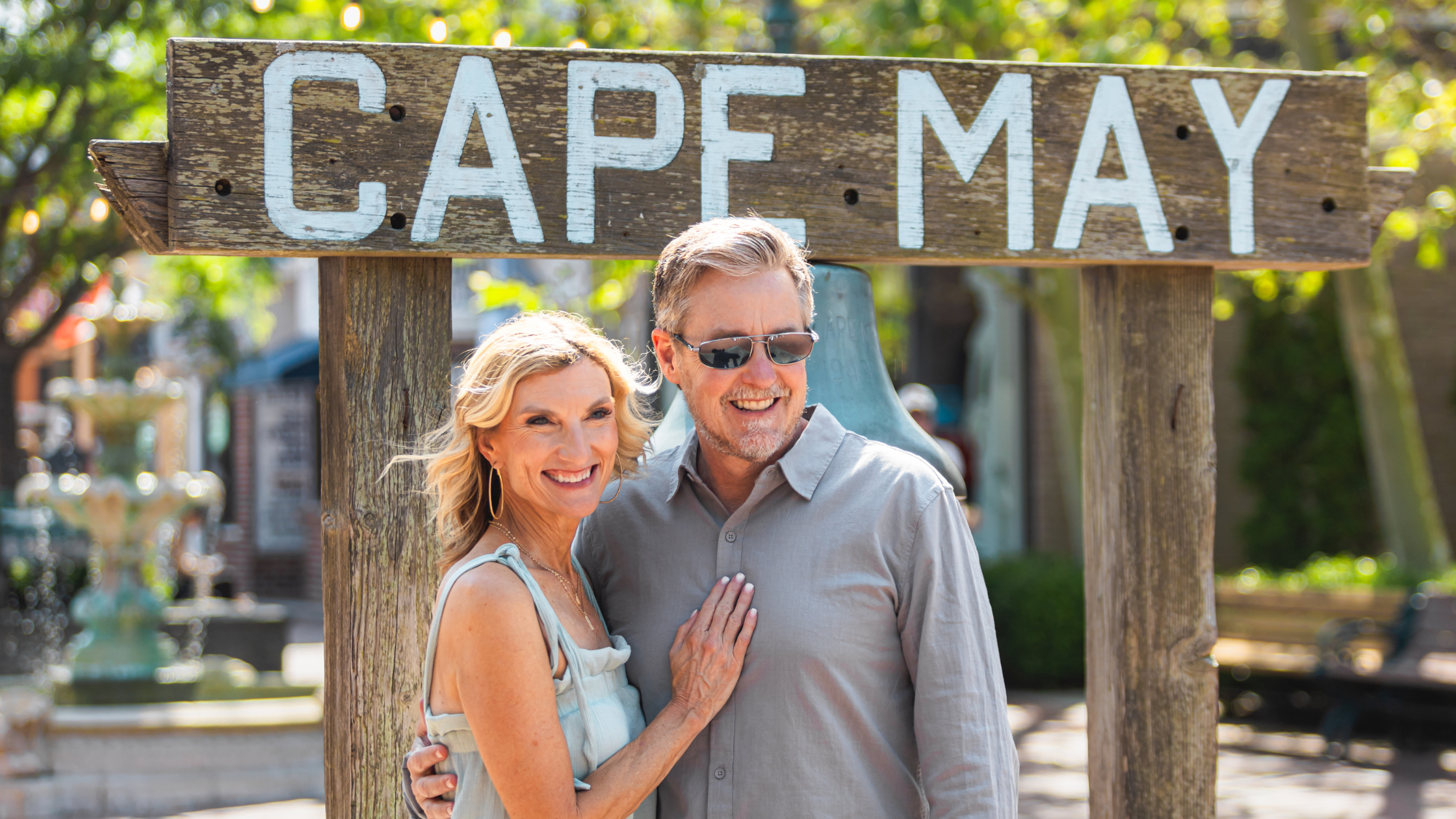 Couple posing in front of Cape May sign