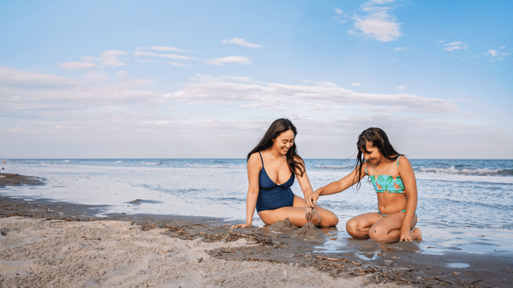 Mother and daughter building a sand castle on a New Jersey beach