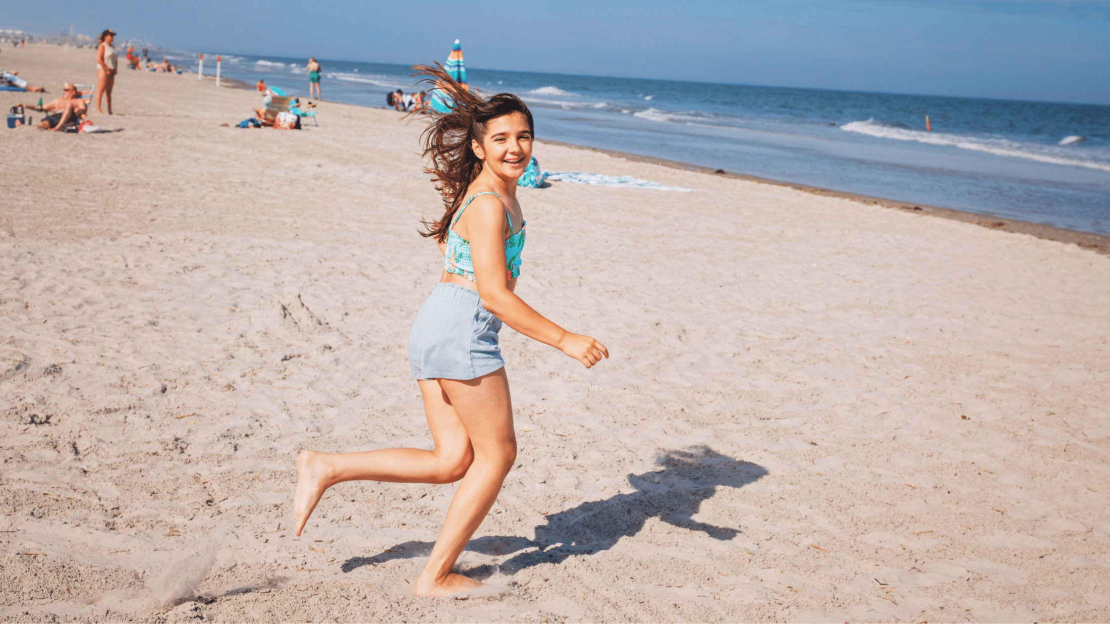 Young girl running on the beach