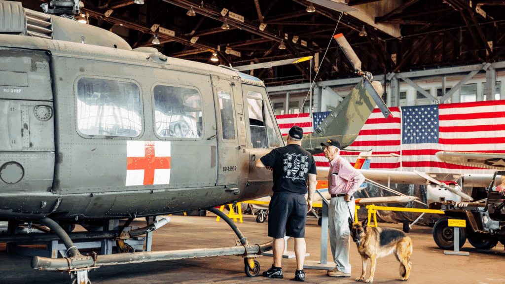 Two men looking at a helicopter at Wildwood's NAS Museum