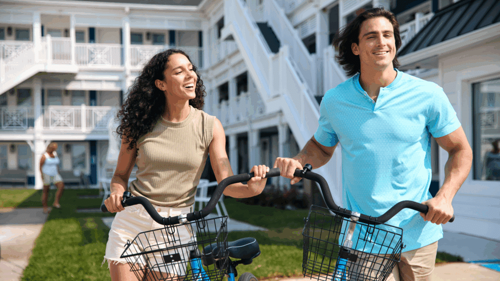 Couple standing with bicycles in front of Mahalo Cape May in NJ
