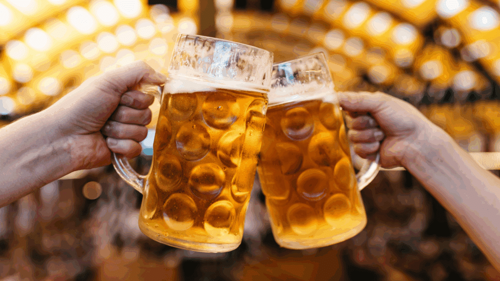 Two steins of beer clinking together