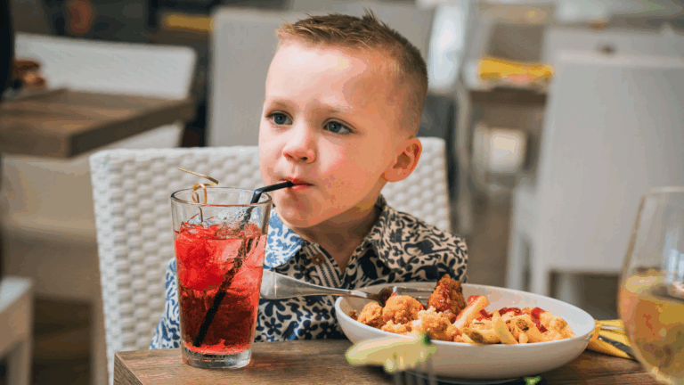 Child sipping a colorful drink at Coastal Blue restaurant near Cape May, NJ