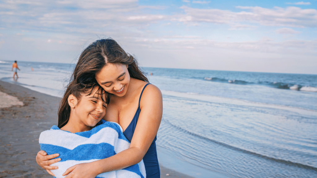 Mother hugging a daughter on the beach in Wildwood, NJ