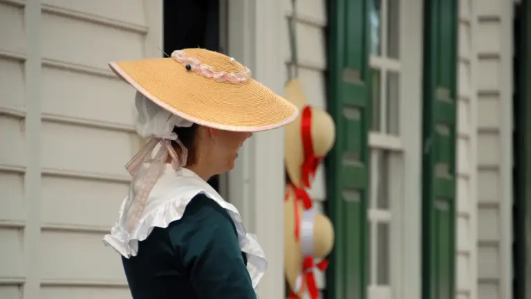 Historic woman in front of a home